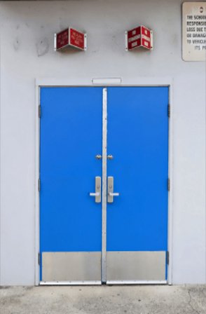 The Anodized Aluminum Kickplate is                                                                                                                                               installed on a blue color door